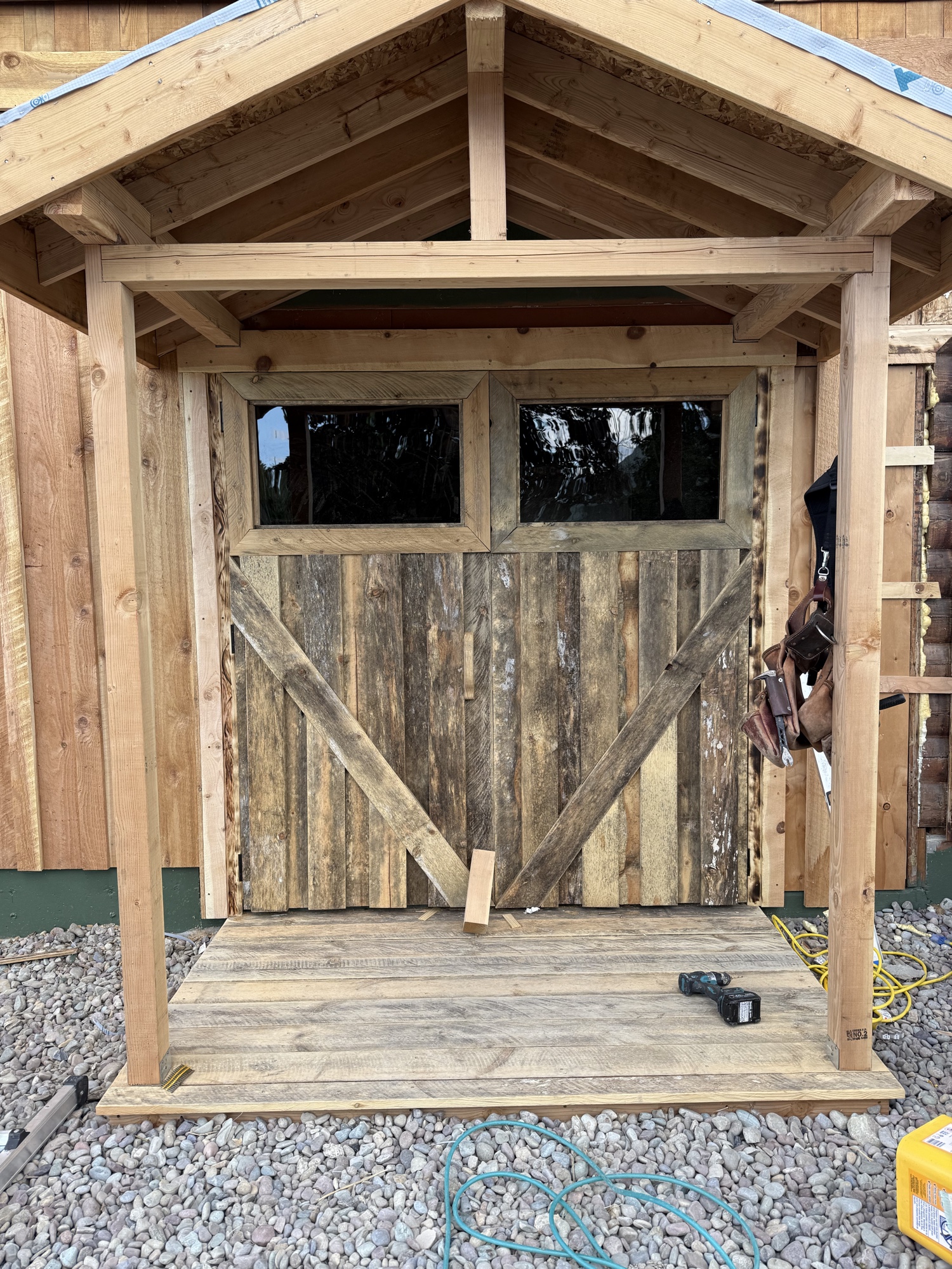 Close-up of custom reclaimed wood barn doors with Z-brace pattern and glass lites