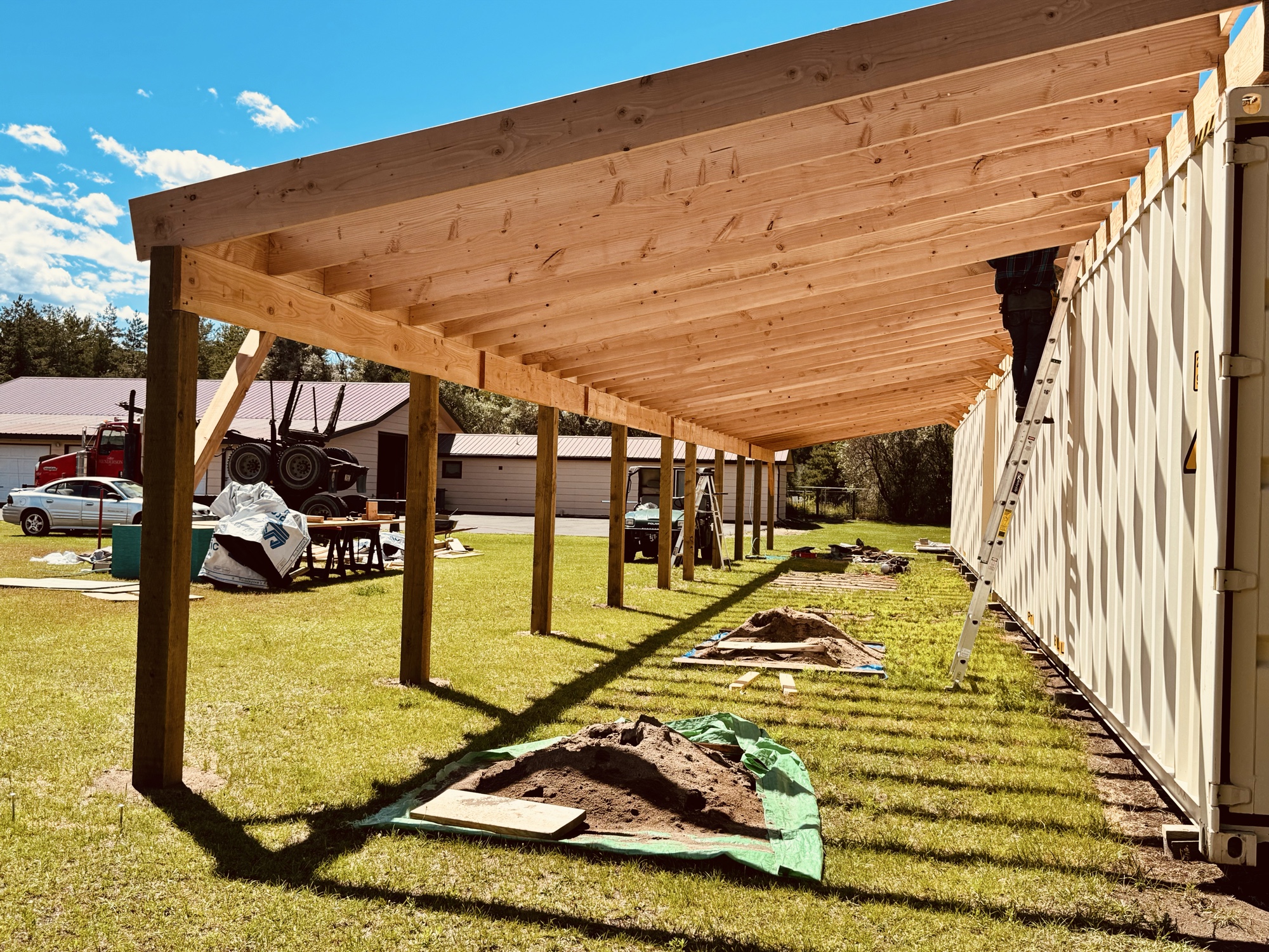 Custom timber roof structure built over shipping containers